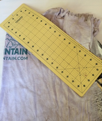 Take your cutting mat and angle it to make one side of the pyramid.